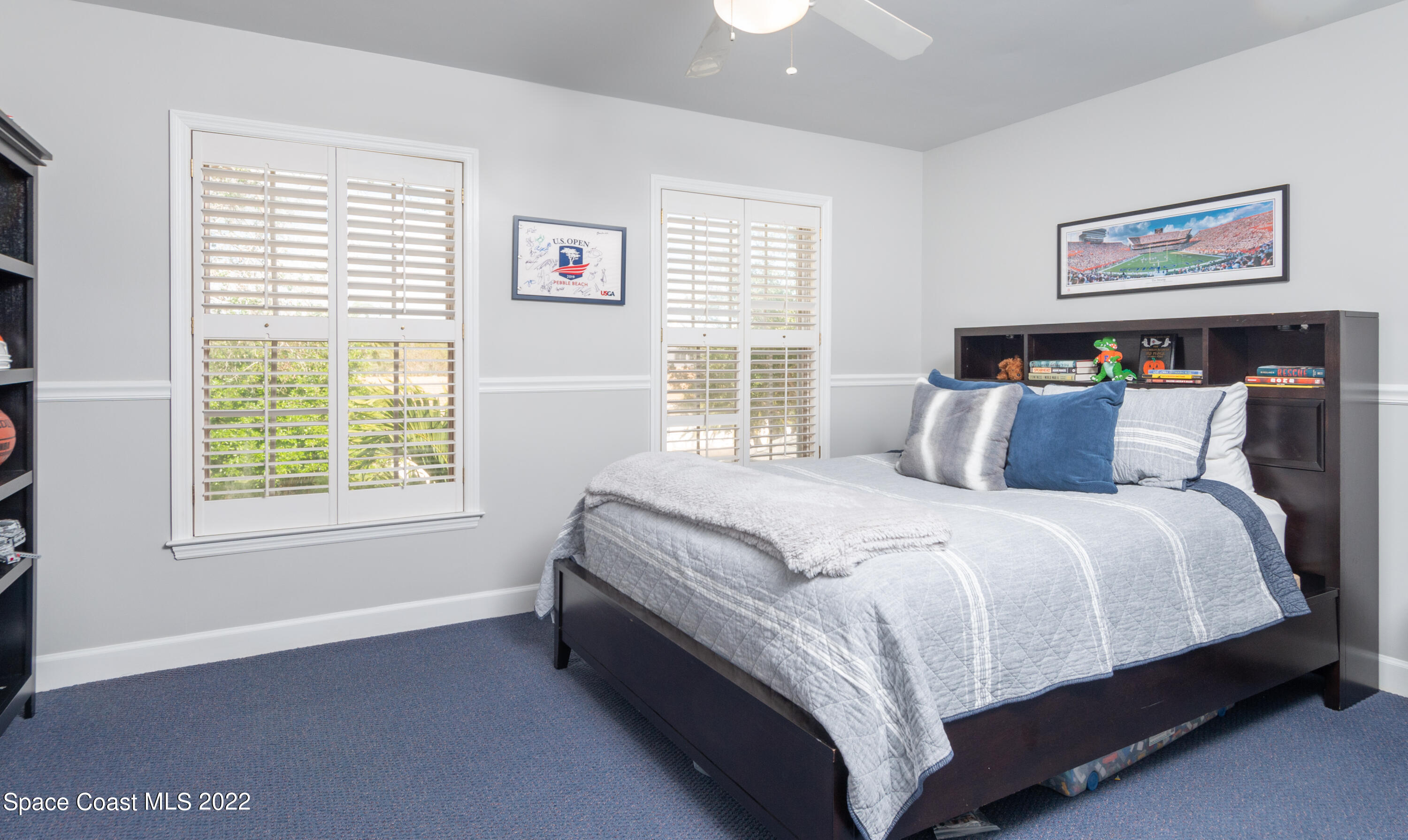 870 Kerry Downs Circle Melbourne, FL 32940 - Photo 28 of 41 a large bed sitting in a bedroom next to a window