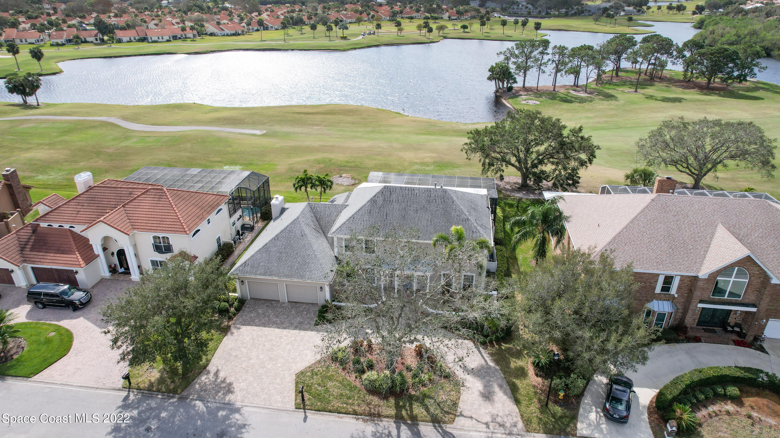 870 Kerry Downs Circle Melbourne, FL 32940 - Photo 4 of 41 an aerial view of a house with a garden and lake view