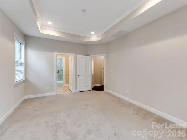 an empty room with windows and closet