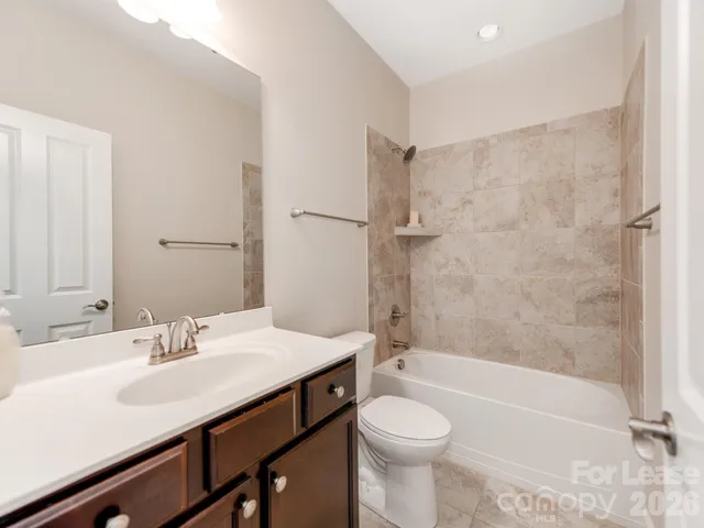 a bathroom with a sink a toilet and a bathtub