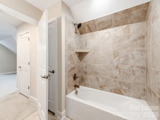 a bathroom with a bathtub and shower