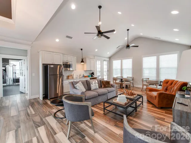a living room with furniture ceiling fan and a rug