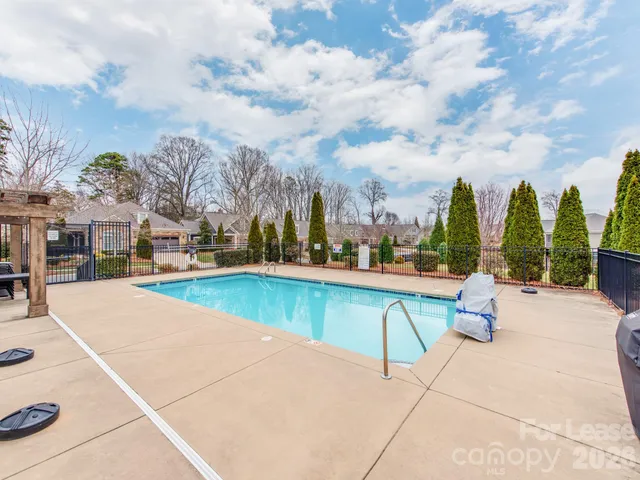 a view of swimming pool with outdoor seating and plants