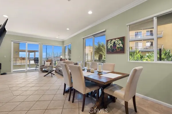 a view of a dining room with furniture and a potted plant