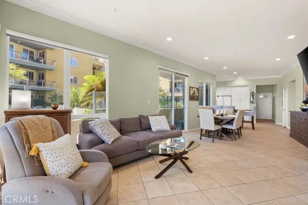 a living room with furniture and a dining table with projector the view
