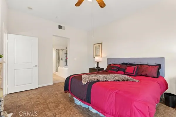 a bedroom with a bed and a lamp