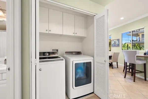 a view of kitchen with stainless steel appliances granite countertop a stove and a refrigerator