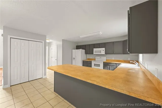 a large kitchen with stainless steel appliances a large counter top and a stove