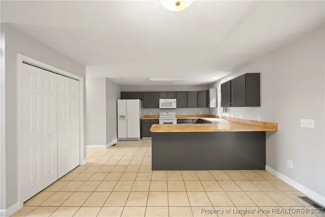 a view living room with kitchen island granite countertop a rug and a view of living room