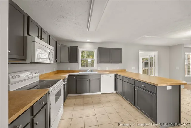a kitchen with a sink cabinets and window