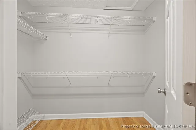 a view of a closet with racks on the wall