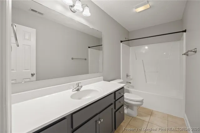 a bathroom with a sink a toilet a shower and a mirror