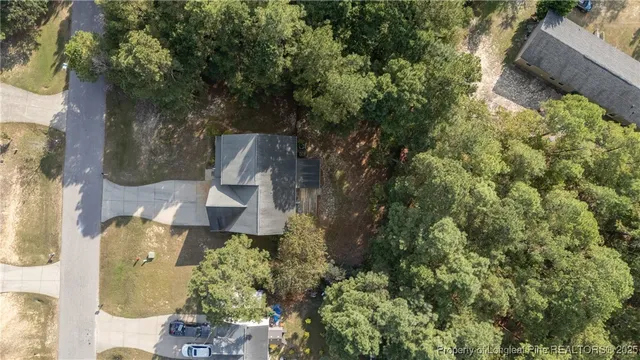 an aerial view of a house with a yard and garden