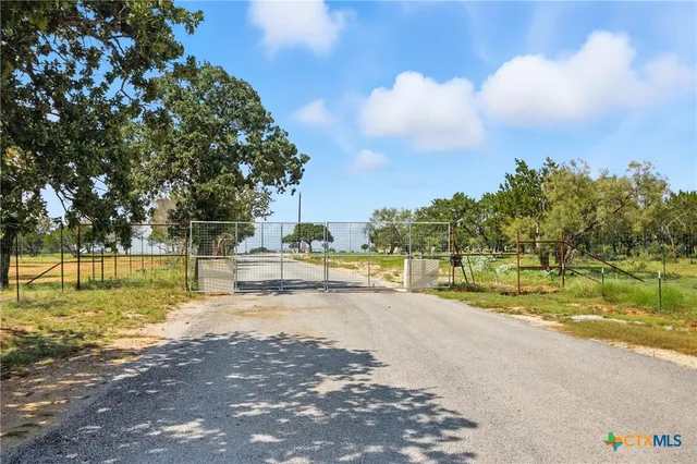 a view of a water pond with green yard