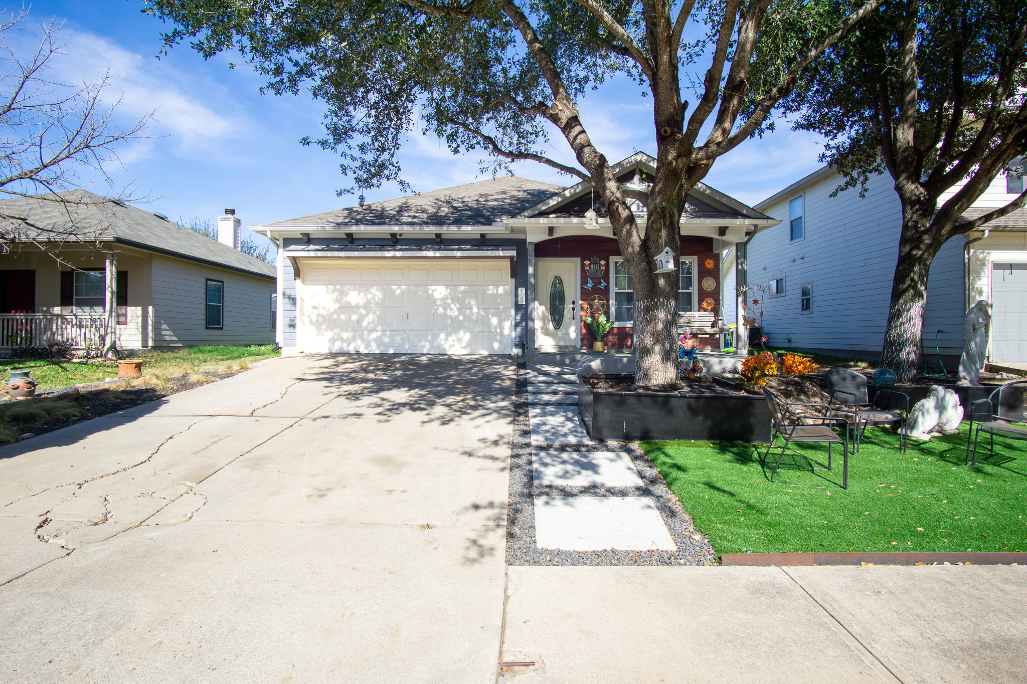 a front view of a house with a yard garage and outdoor seating