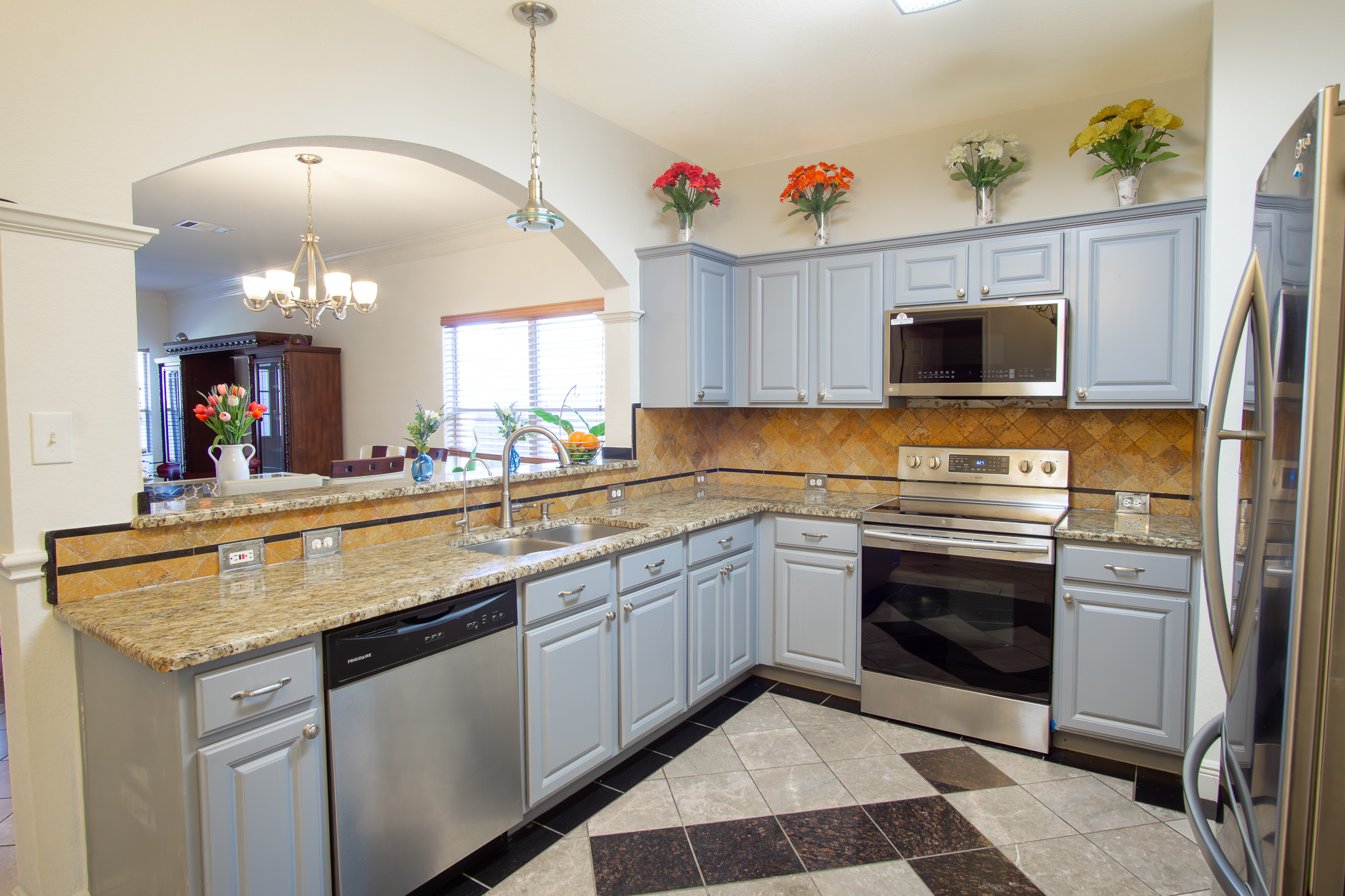 11500 Dimmit Street Manor, TX 78653 - Photo 4 of 20 a kitchen with a sink stove and microwave