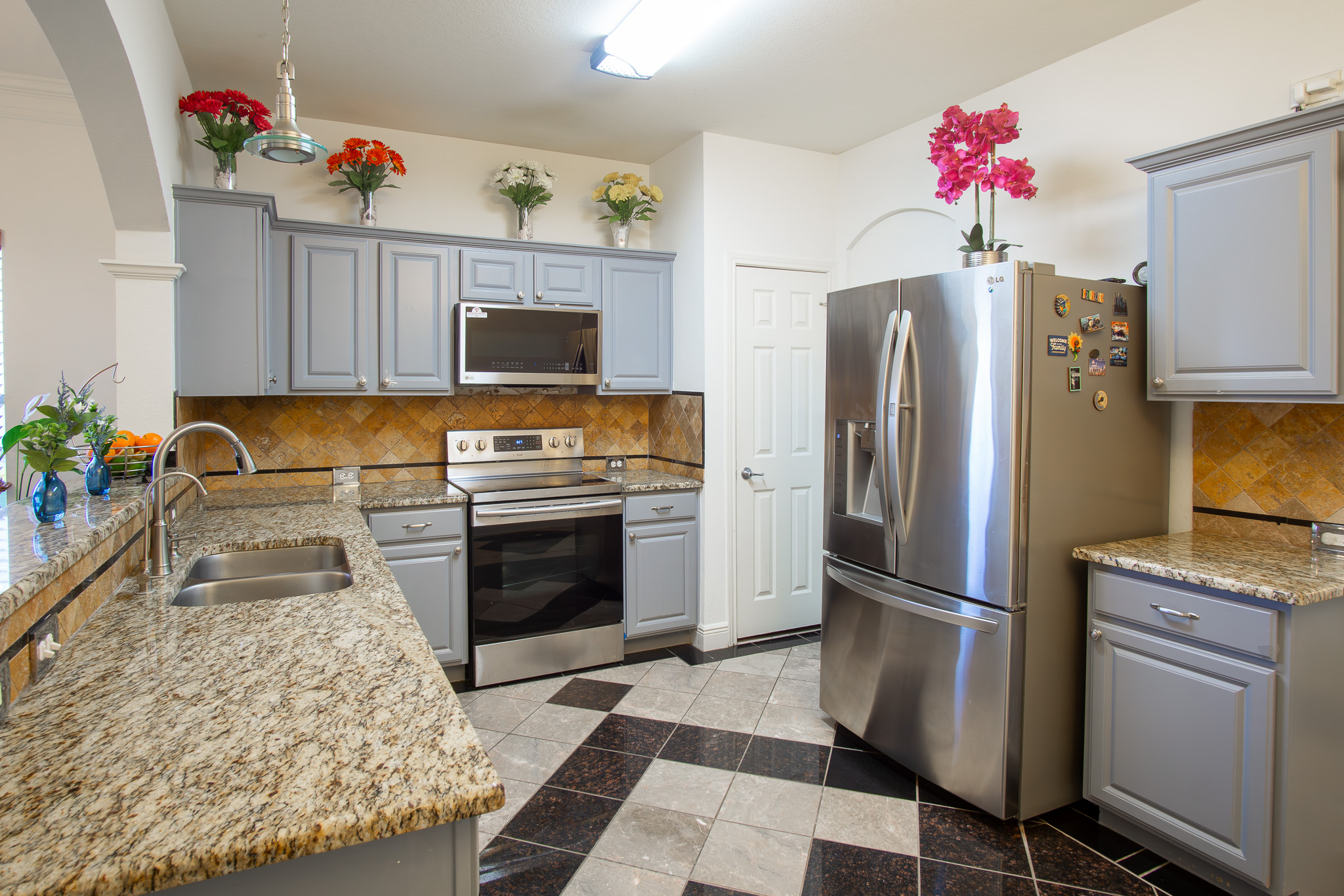 11500 Dimmit Street Manor, TX 78653 - Photo 5 of 20 a kitchen with white cabinets and stainless steel appliances