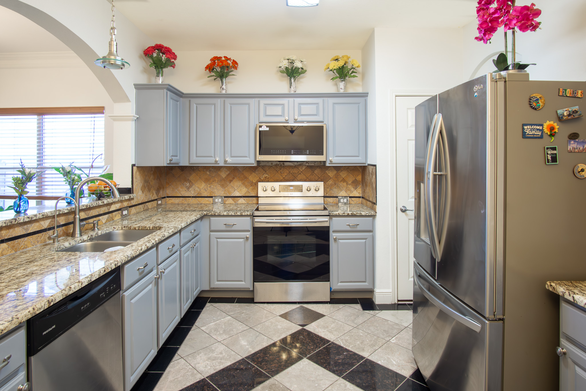 11500 Dimmit Street Manor, TX 78653 - Photo 6 of 20 a kitchen with stainless steel appliances granite countertop a refrigerator and a sink