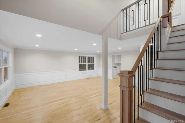 a view of entryway with wooden floor and stairs