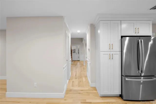 a view of a refrigerator in kitchen and wooden floor
