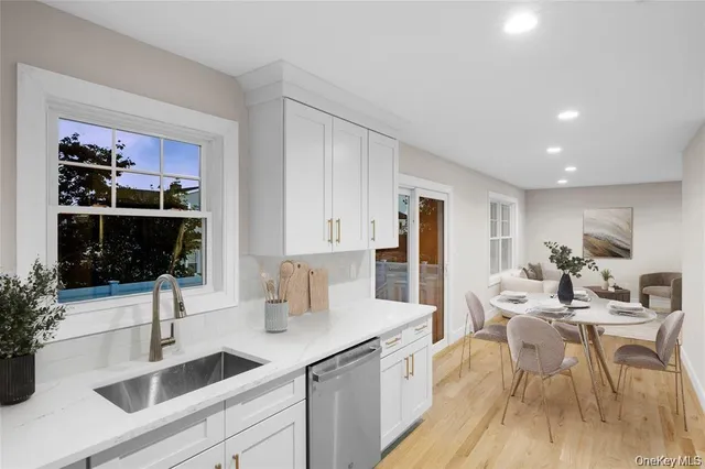 a kitchen with a sink cabinets and wooden floor