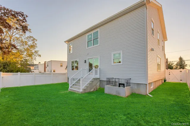 a view of a house with a yard and sitting area