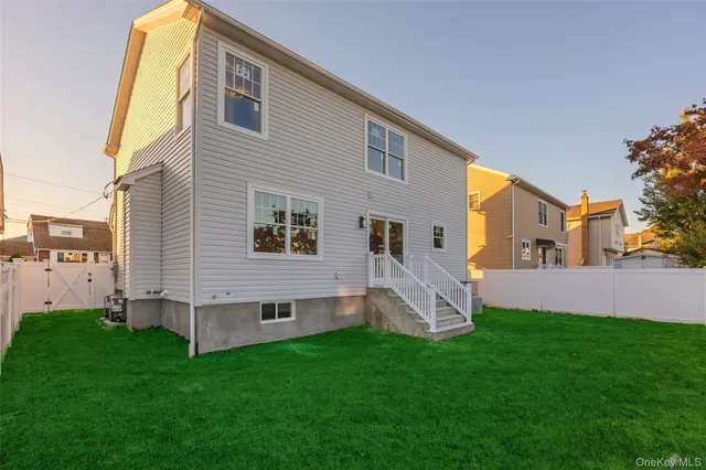 a front view of a house with a garden and yard
