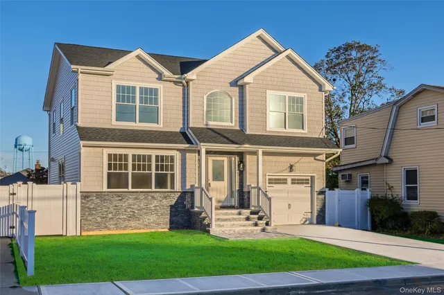 a front view of a house with garden and porch