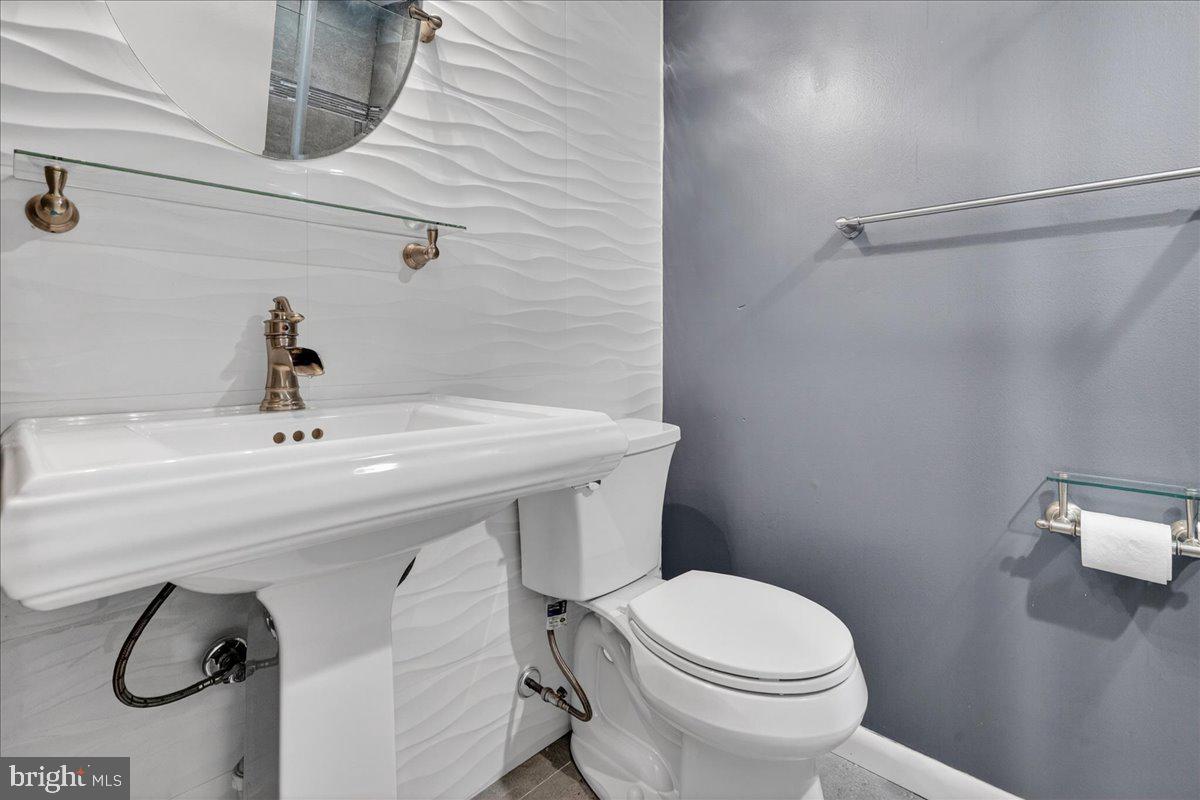 8930 Krewstown Road, Unit 310 Philadelphia, PA 19115 - Photo 19 of 32 a bathroom with a sink a toilet and shower