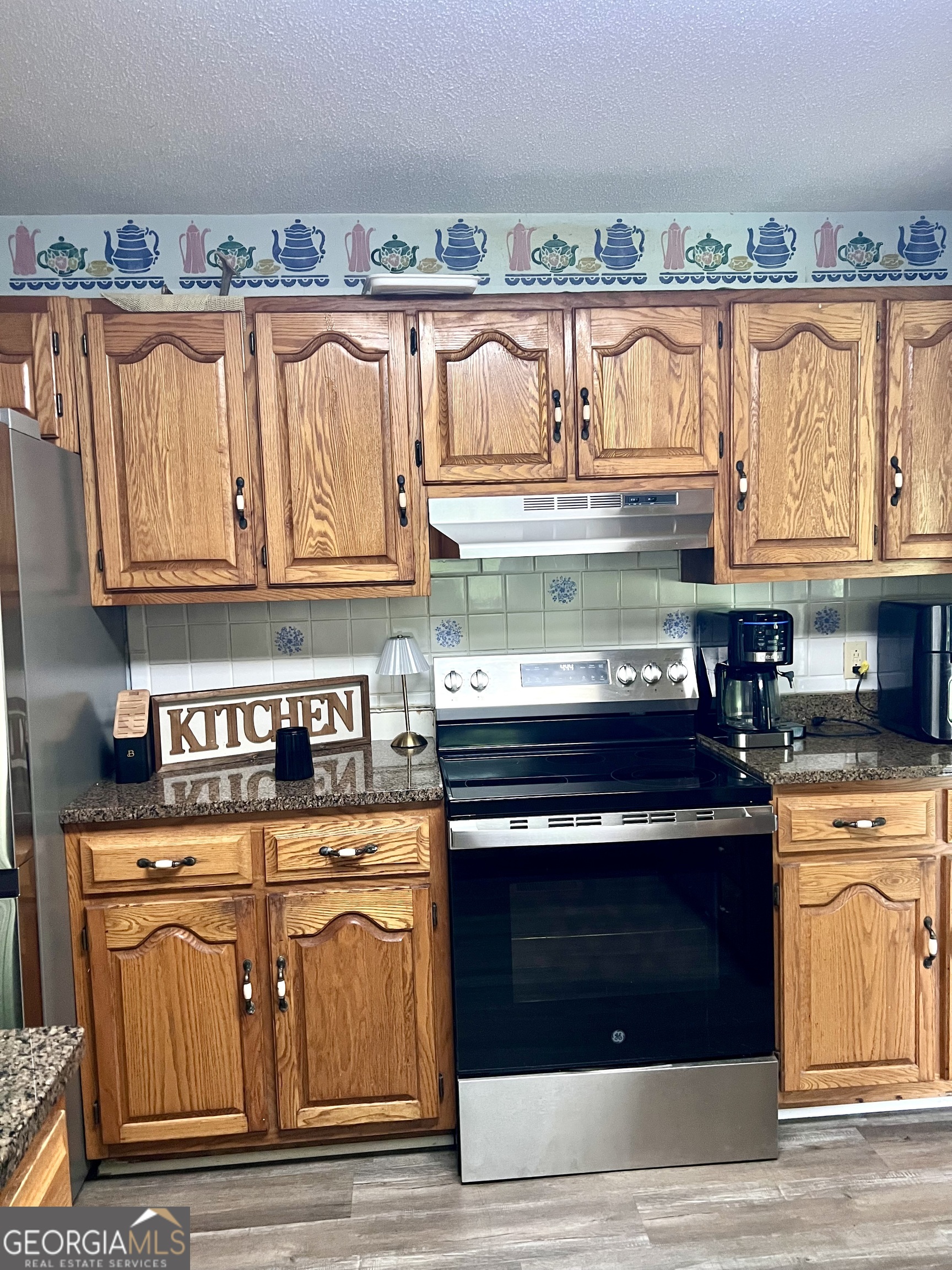 46 Ray Roderick Road Eastman, GA 31023 - Photo 12 of 22 a kitchen with stainless steel appliances granite countertop a stove and a microwave