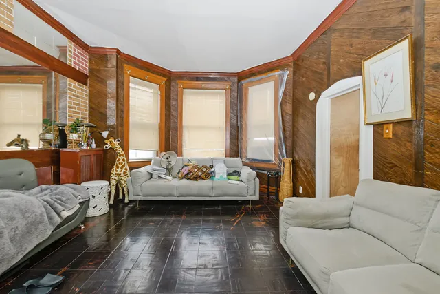 a living room with furniture and large windows