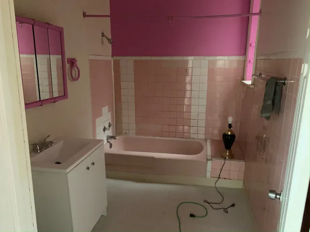 a bathroom with a bathtub and a shower
