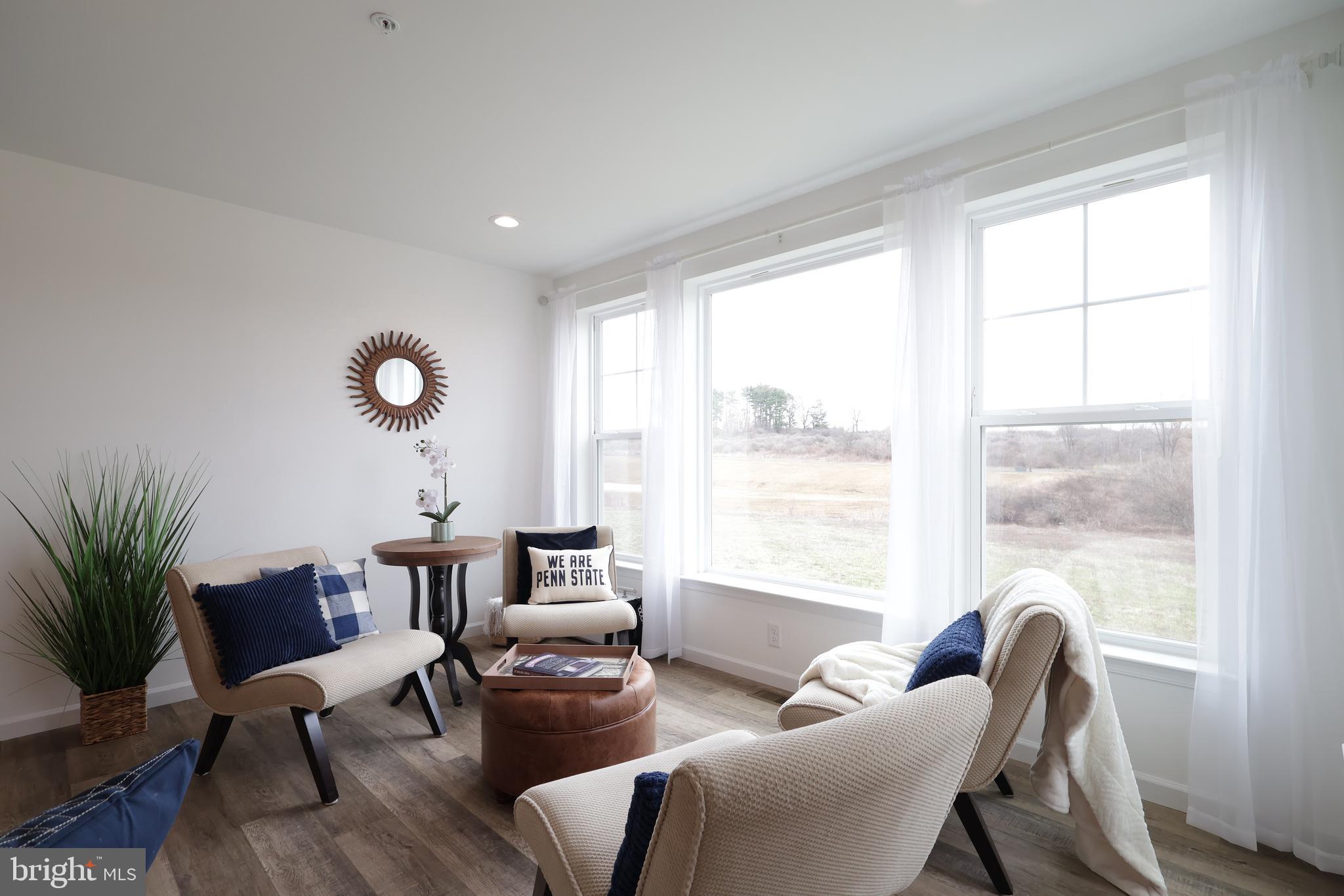 154 Magnolia Lane State College, PA 16803 - Photo 21 of 60 a living room with furniture and a large window