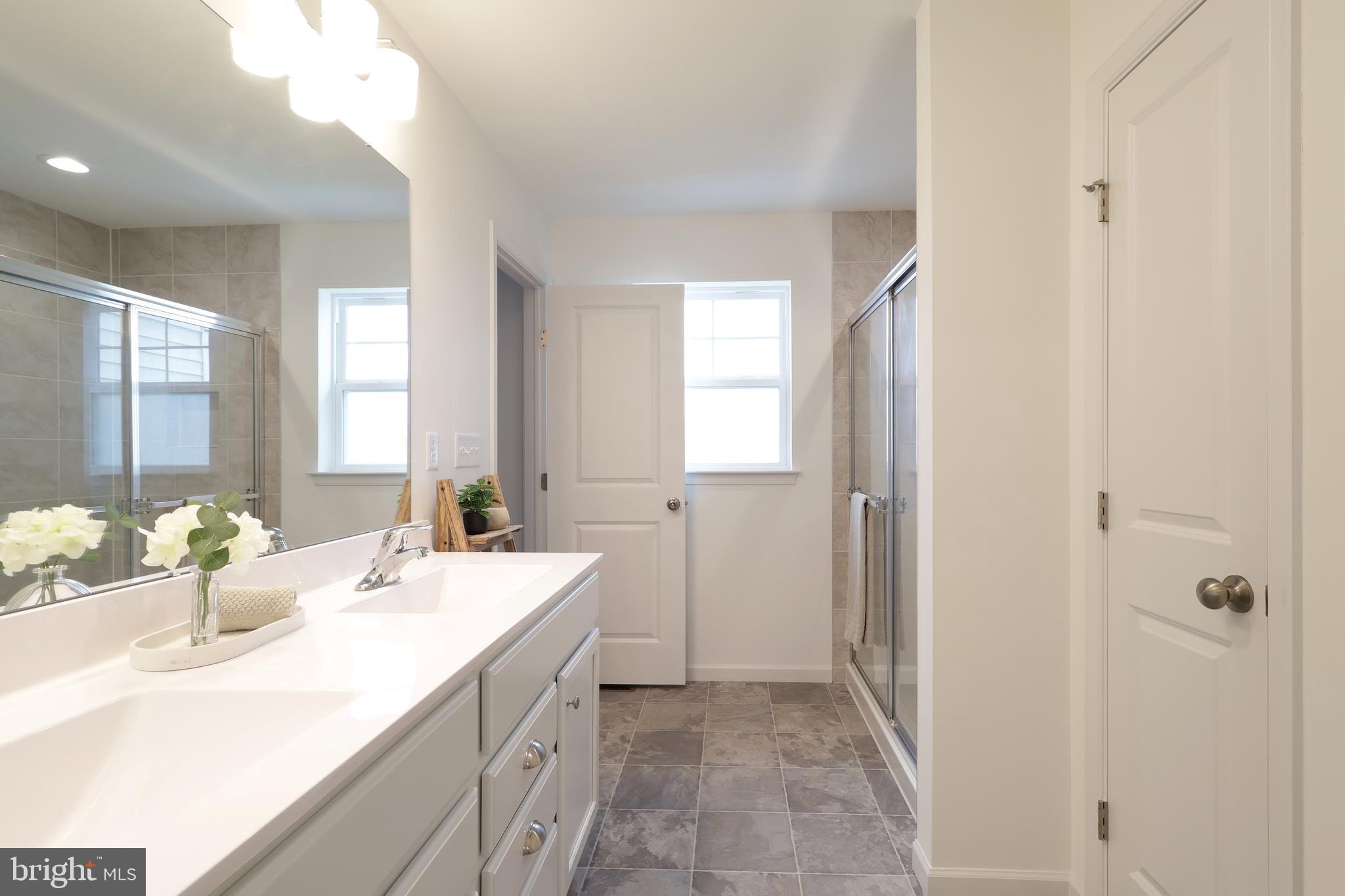 154 Magnolia Lane State College, PA 16803 - Photo 34 of 60 a bathroom with a sink and a mirror