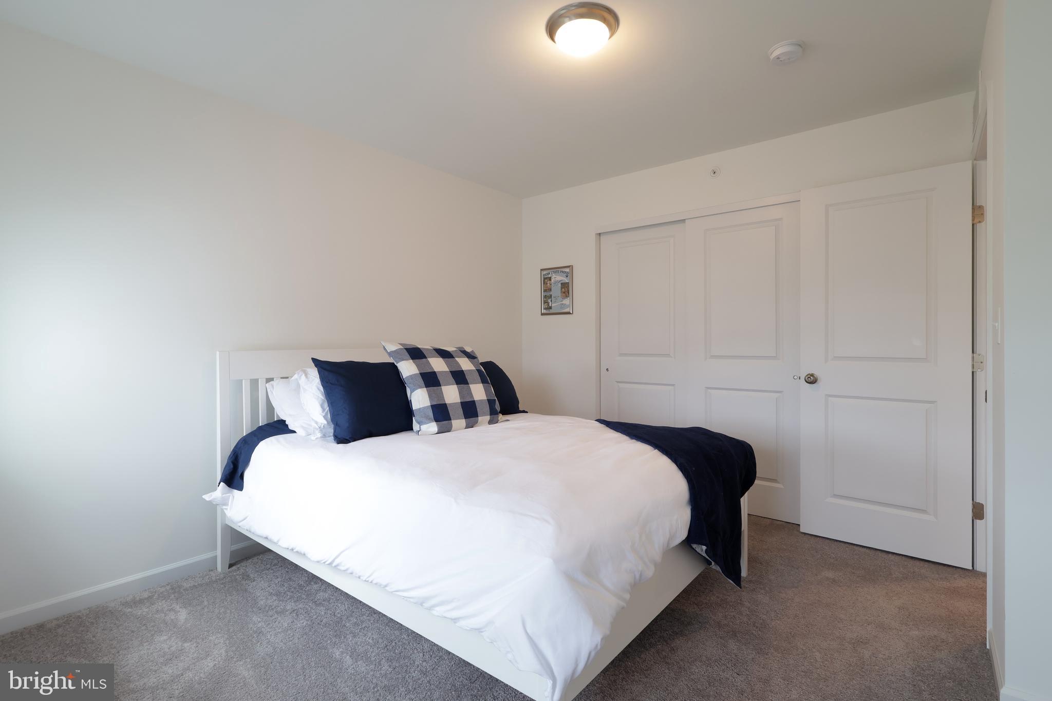 154 Magnolia Lane State College, PA 16803 - Photo 37 of 60 a bedroom with a bed and a night lamp