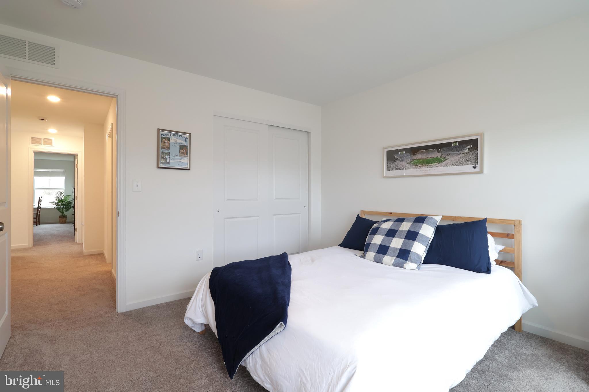154 Magnolia Lane State College, PA 16803 - Photo 39 of 60 a bedroom with a bed and a chair