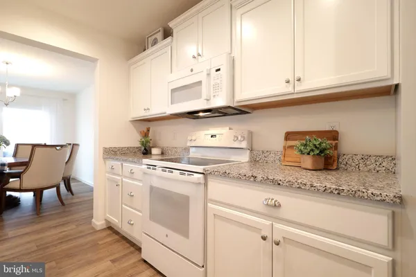 a large kitchen with a table and chairs