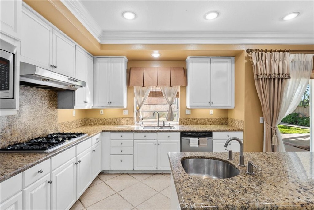 5531 San Carlos Court Rancho Cucamonga, CA 91739 - Photo 12 of 54 a kitchen with granite countertop a sink a stove and cabinets