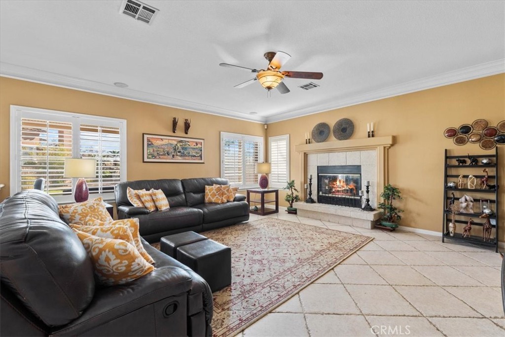 5531 San Carlos Court Rancho Cucamonga, CA 91739 - Photo 14 of 54 a living room with furniture a fireplace and a large window