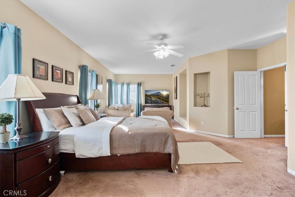 5531 San Carlos Court Rancho Cucamonga, CA 91739 - Photo 28 of 54 a bedroom with a large bed and a chandelier