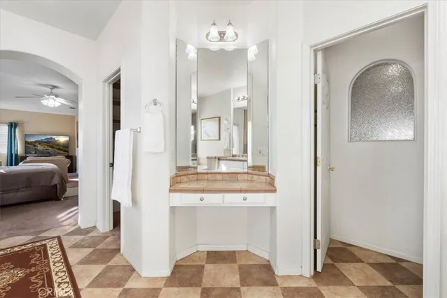 a en suite bathroom with a sink and a mirror