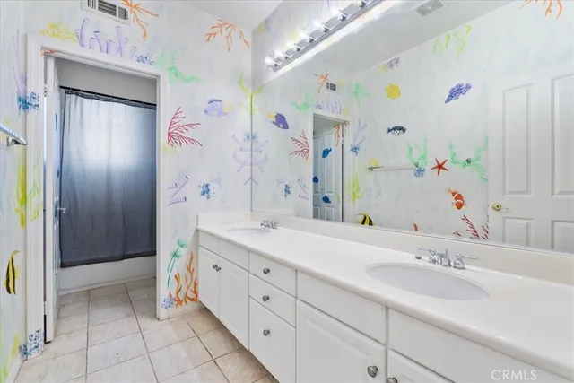 a spacious bathroom with a double vanity sink mirror and shower