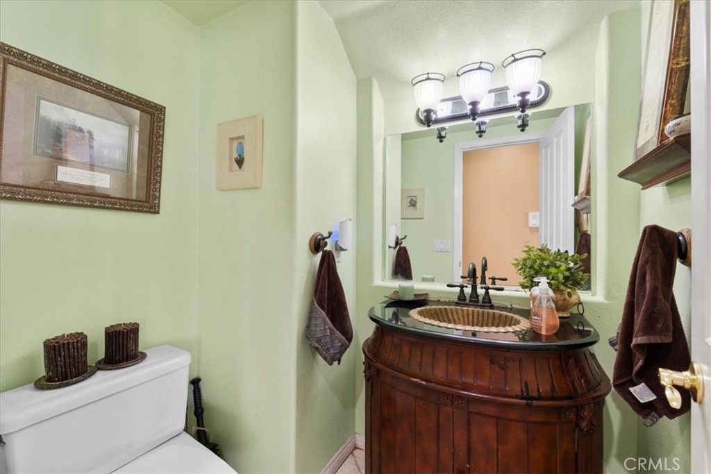 5531 San Carlos Court Rancho Cucamonga, CA 91739 - Photo 7 of 54 a bathroom with a sink a mirror and a toilet