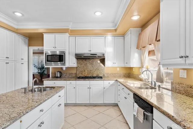 a large kitchen with stainless steel appliances granite countertop a sink a stove and cabinets