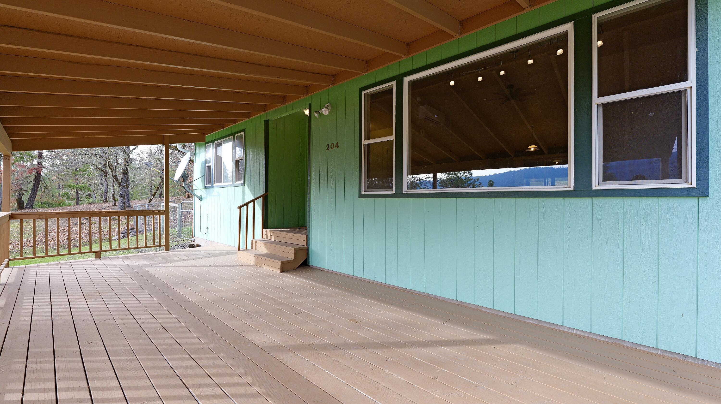 204 Shipley Terrace Prospect, OR 97536 - Photo 36 of 61 a view of a backyard of a house with a wooden deck and furniture