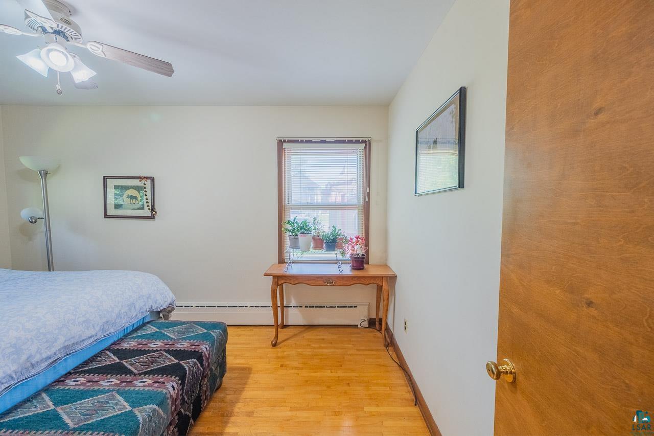 101 2nd Avenue North Biwabik, MN 55708 - Photo 16 of 44 Hardwood flooring, a window with natural light, and a ceiling fan with integrated lighting