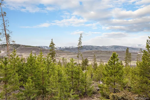 a view of mountain with beach and background