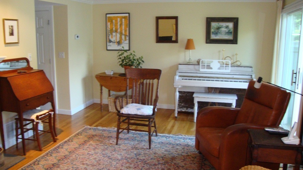 112 Jericho Road, Unit 112 Weston, MA 02493 - Photo 5 of 17 a living room with furniture a rug and a window