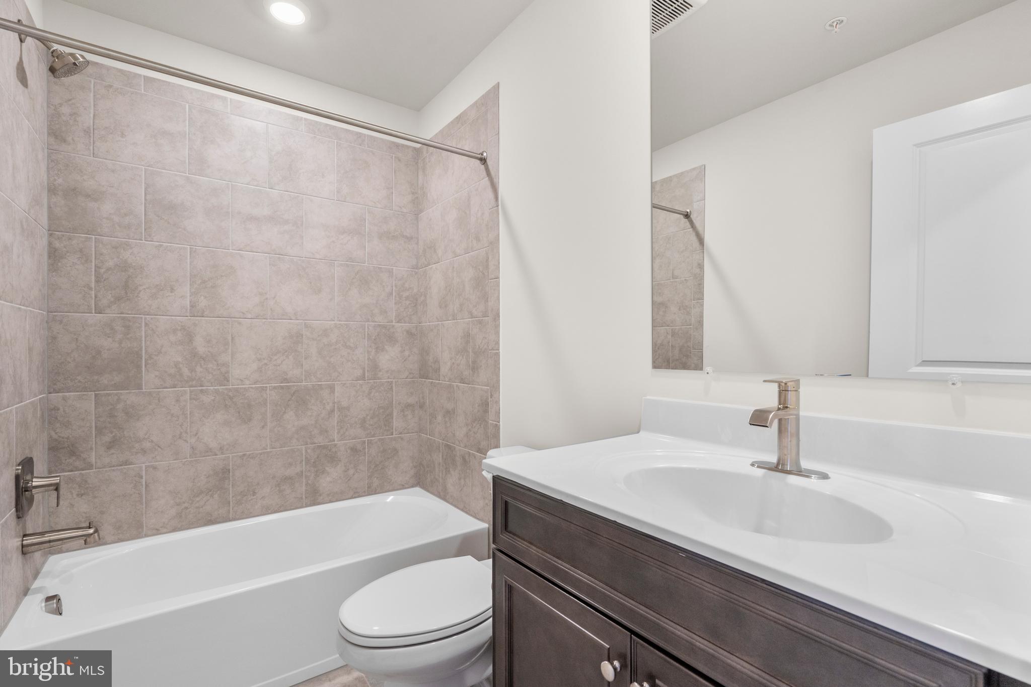 1826 Parham Way Windsor Mill, MD 21244 - Photo 27 of 37 a bathroom with a sink a toilet and a bathtub