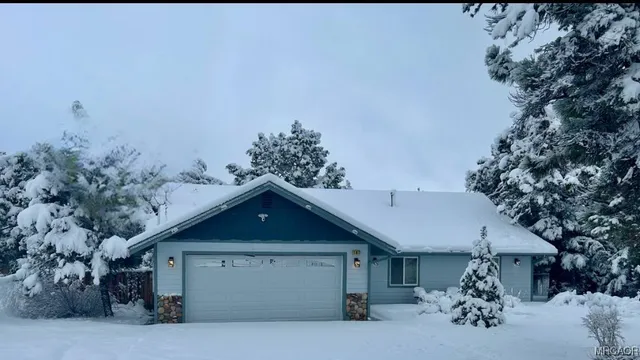 a view of a house with a yard and garage